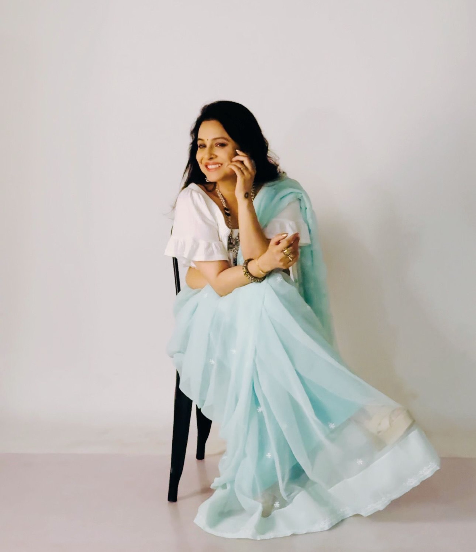 Light blue saree seated
